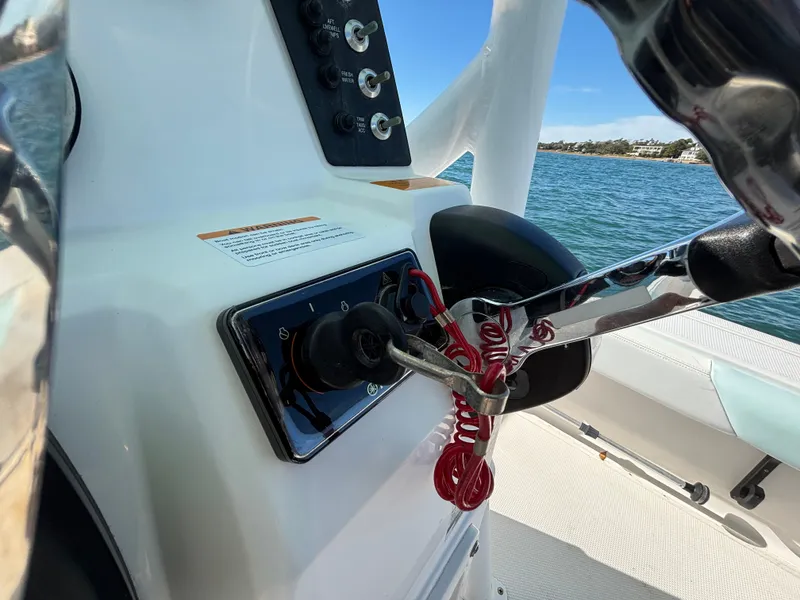Slide: The Image of Helm console of a 2018 Robalo 246 Cayman boat on the water. - 32