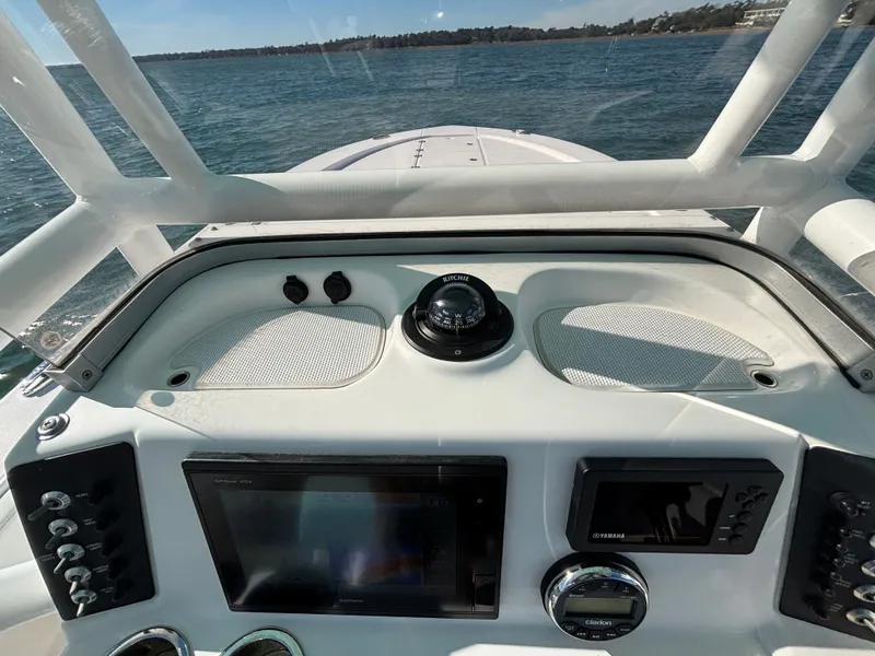 Slide: The Image of Dashboard of a 2018 Robalo 246 Cayman boat on the water. - 34
