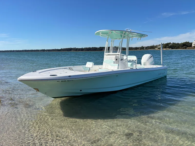 Slide: The Image of 2018 Robalo 246 Cayman boat anchored in clear water. - 4