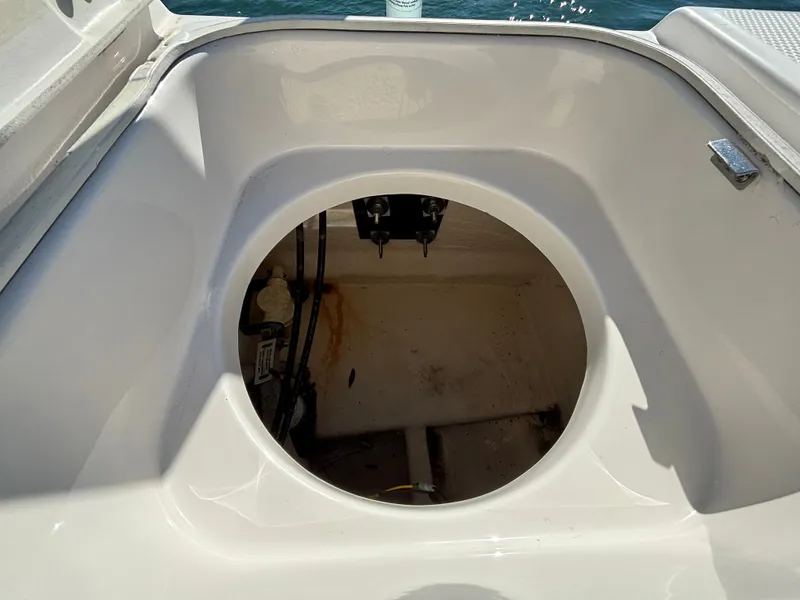 Slide: The Image of Robalo 246 Cayman 2018 boat hatch with open storage compartment. - 41