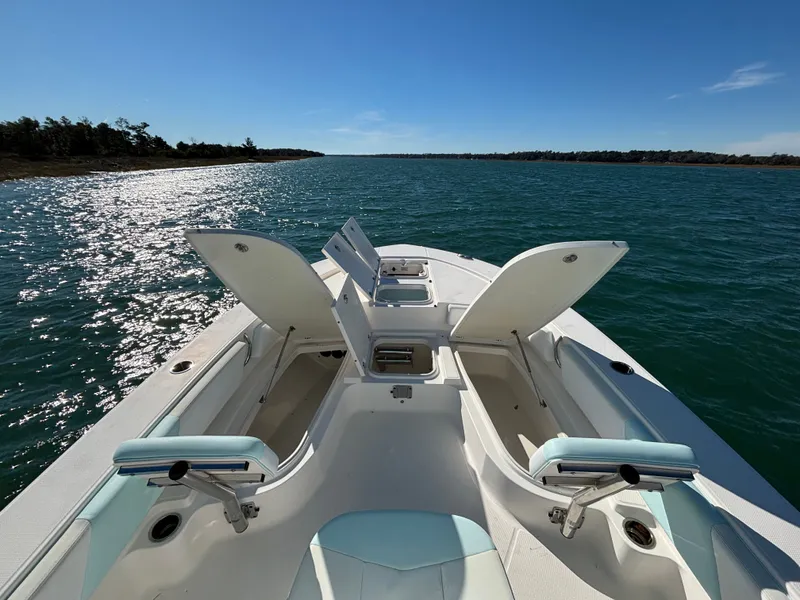 Slide: The Image of 2018 Robalo 246 Cayman on open water with storage compartments. - 46