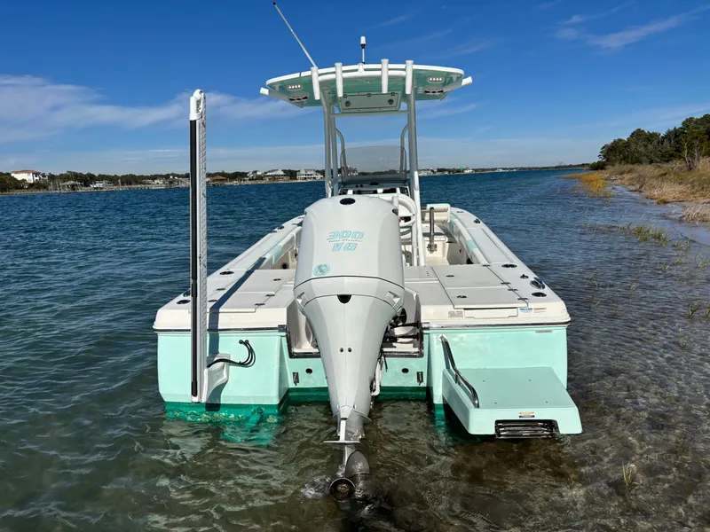 Slide: The Image of 2018 Robalo 246 Cayman boat in clear water by the shore. - 7