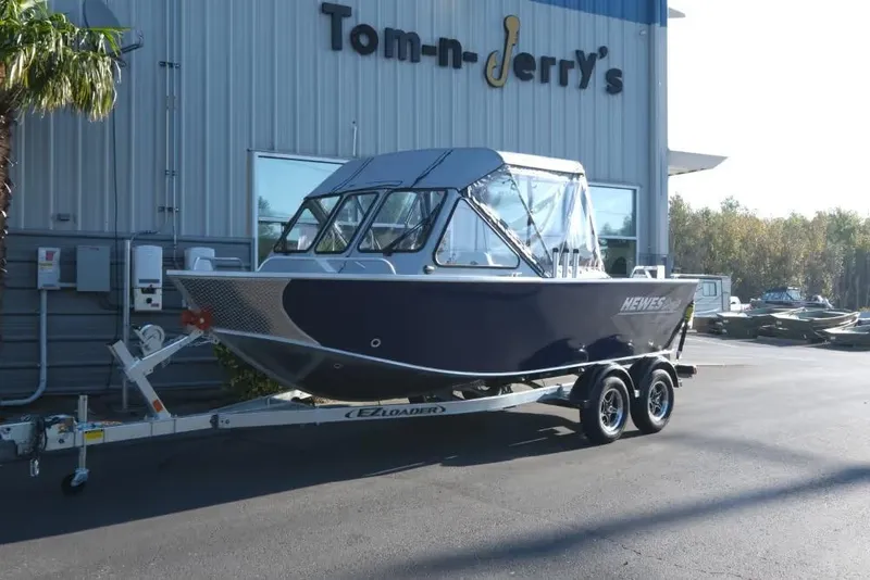 The Image of 2026 Hewescraft 180 Pro-V ET boat on trailer at dealership. - 1