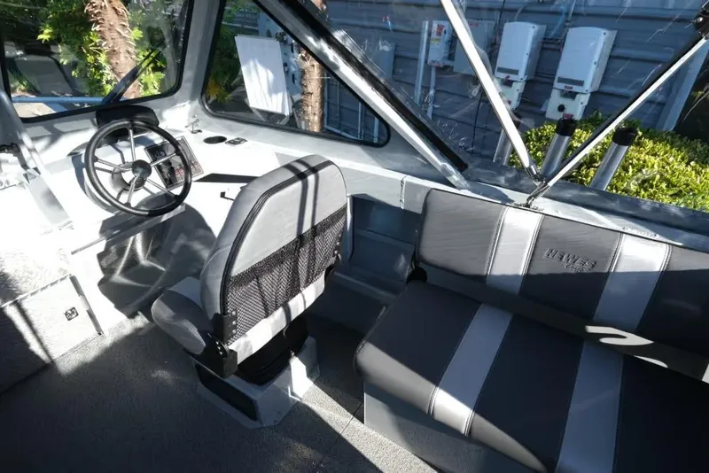 Slide: The Image of Interior of 2026 Hewescraft 180 Pro-V ET boat with steering wheel and seating. - 11