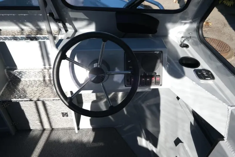 Slide: The Image of Steering wheel and dashboard of 2026 Hewescraft 180 Pro-V ET boat interior. - 12