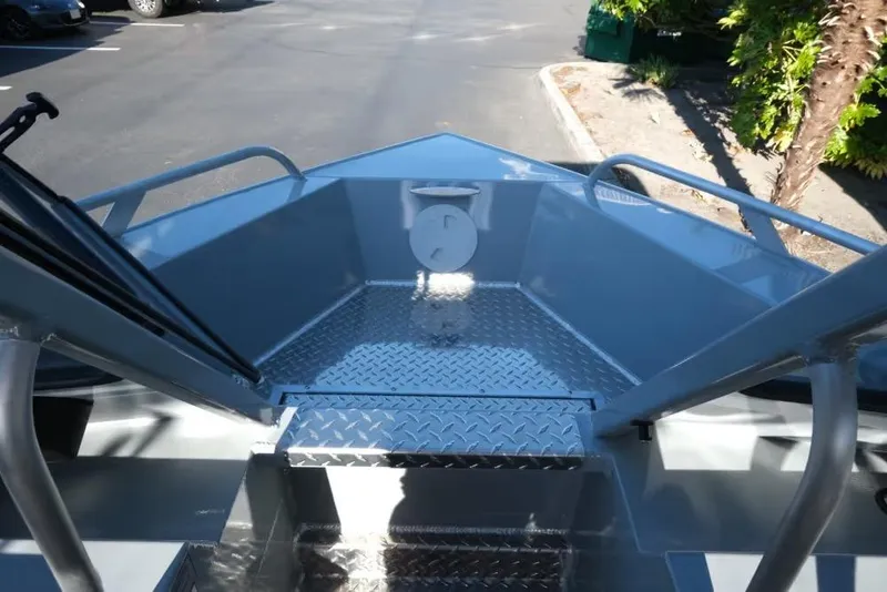 Slide: The Image of 2026 Hewescraft 180 Pro-V ET boat interior with diamond plate flooring and railing. - 13