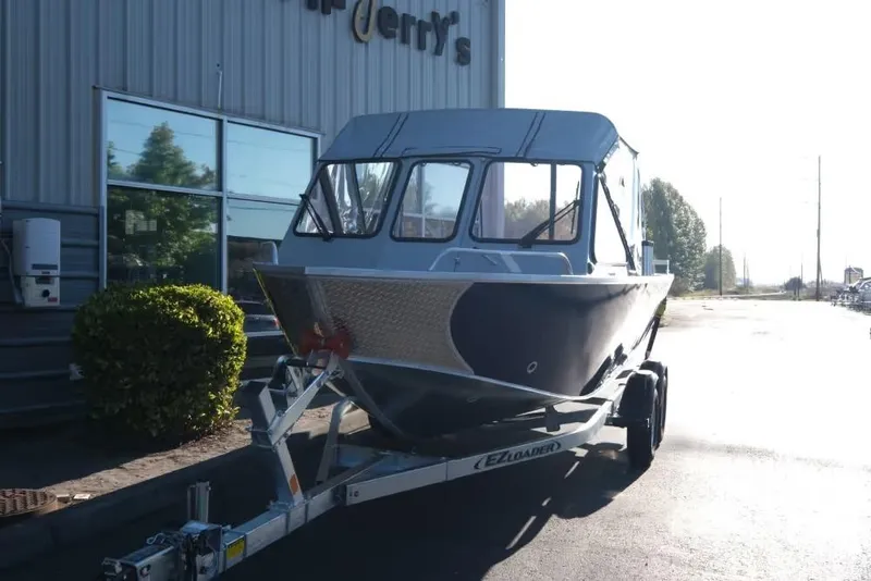 Slide: The Image of 2026 Hewescraft 180 Pro-V ET boat on trailer outside a building. - 3