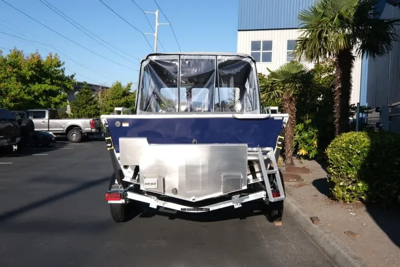 Slide: The Image of 2026 Hewescraft 180 Pro-V ET boat on trailer, parked outdoors. - 5