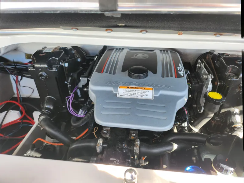 Slide: The Image of 2012 Crownline 195 SS boat engine compartment with visible components and wiring. - 21
