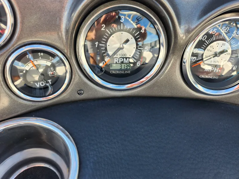 Slide: The Image of Dashboard of 2012 Crownline 195 SS boat showing RPM and volt gauges. - 22