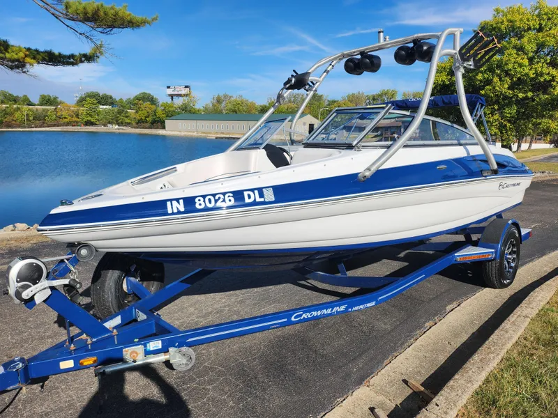 Slide: The Image of 2012 Crownline 195 SS boat on trailer by a lake, sunny day. - 8