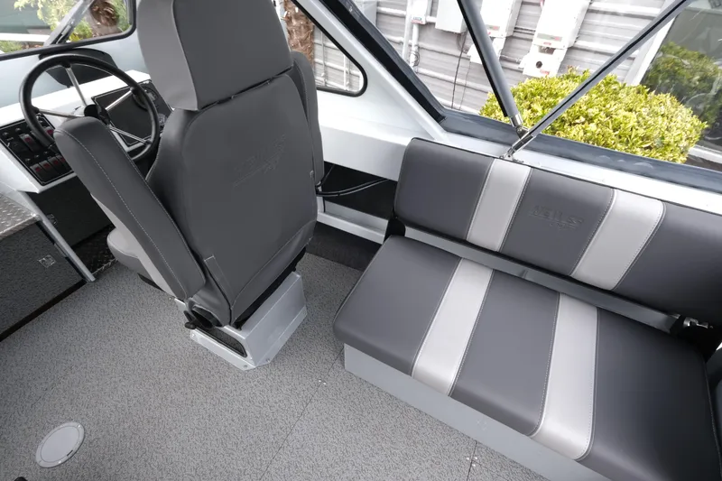 Slide: The Image of 2026 Hewescraft 190 SeaRunner ET interior with gray seating and steering wheel. - 11