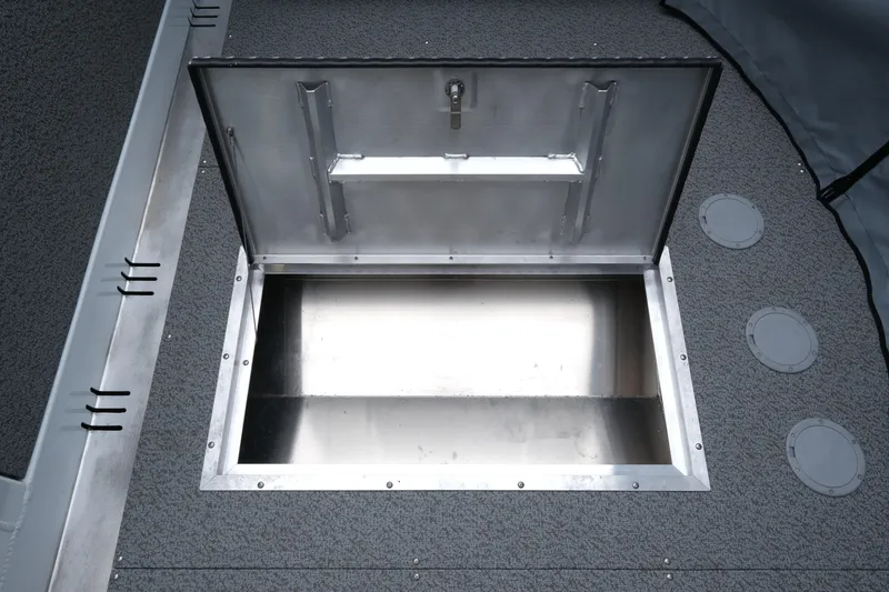 Slide: The Image of Open storage compartment on 2026 Hewescraft 190 SeaRunner ET boat deck. - 16