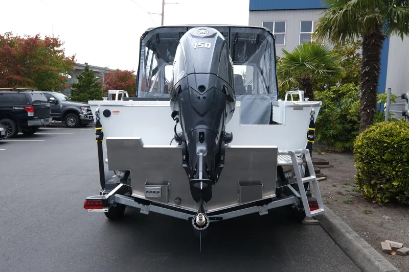 Slide: The Image of 2026 Hewescraft 190 SeaRunner ET boat with outboard motor in parking lot. - 5