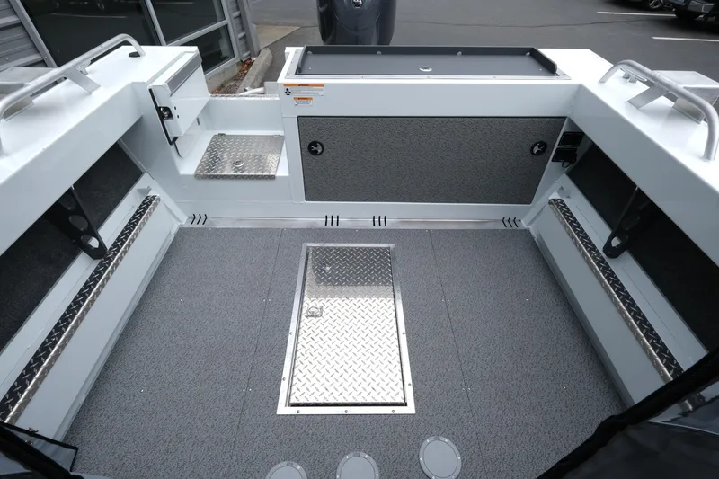 Slide: The Image of 2026 Hewescraft 190 SeaRunner ET boat interior with storage compartments and non-slip flooring. - 8