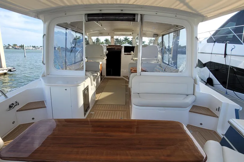 Slide: The Image of Luxurious 2018 MJM 50z yacht interior with elegant seating and wooden table. - 15