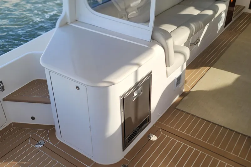 Slide: The Image of 2018 MJM 50z yacht interior with cushioned seating and sleek cabinetry. - 16