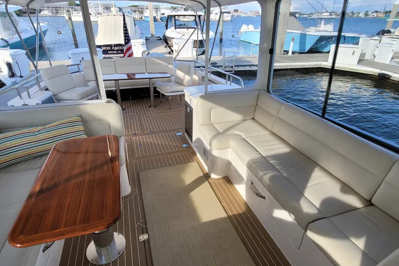 Slide: The Image of Luxurious 2018 MJM 50z yacht interior with elegant seating and wooden table. - 18