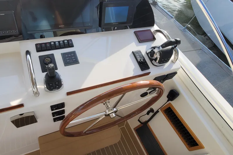 Slide: The Image of Helm of 2018 MJM 50z yacht with wooden steering wheel and modern controls. - 24