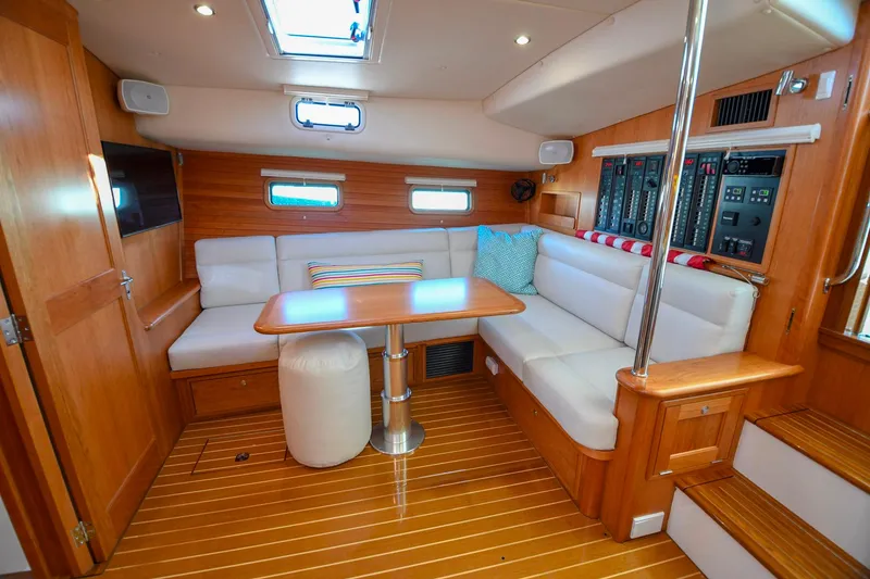 Slide: The Image of Luxurious 2018 MJM 50z yacht interior with elegant wood finish and cozy seating area. - 27