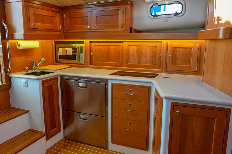 Slide: The Image of Luxurious 2018 MJM 50z yacht kitchen with wooden cabinetry and modern appliances. - 31