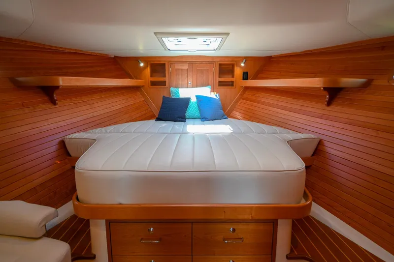 Slide: The Image of Luxurious cabin interior of 2018 MJM 50z yacht with wooden paneling and cozy bedding. - 32
