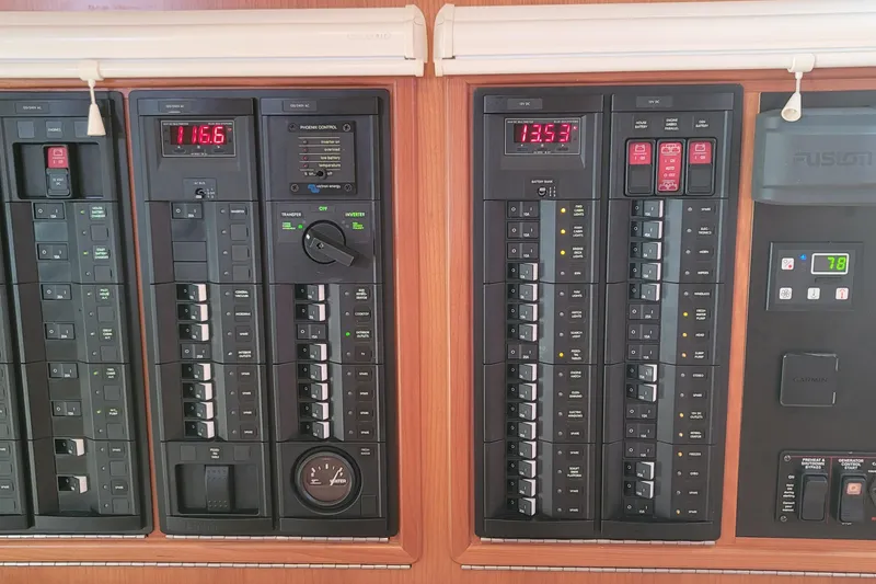 Slide: The Image of Electrical control panel on a 2018 MJM 50z boat, featuring various switches and displays. - 37