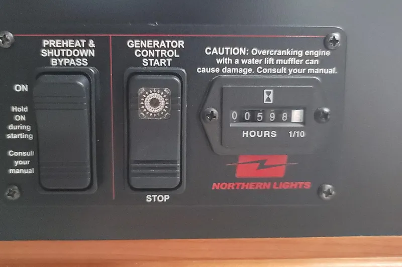 Slide: The Image of Control panel of Northern Lights generator on 2018 MJM 50z boat, showing 598 hours. - 38