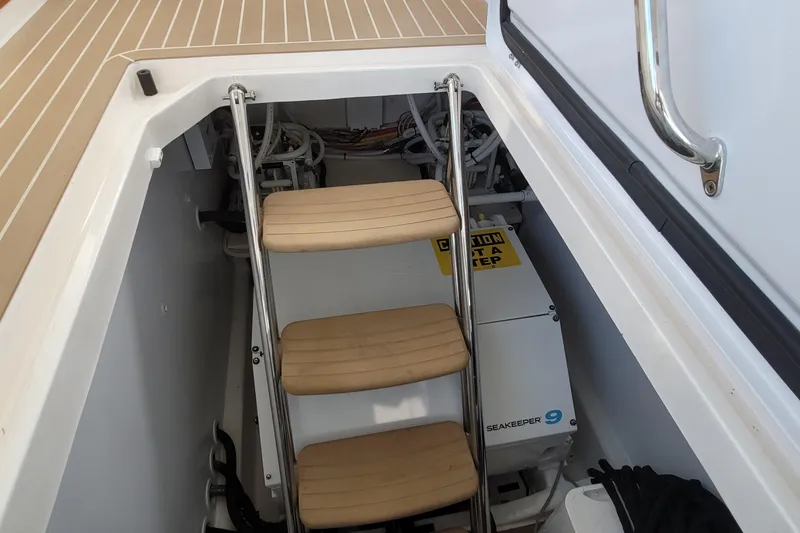 Slide: The Image of Engine room access with steps on a 2018 MJM 50z boat, featuring Seakeeper 9 system. - 40