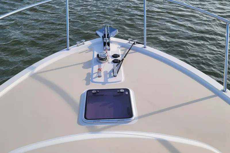 Slide: The Image of Bow of 2018 MJM 50z yacht with anchor and hatch, on calm water. - 47