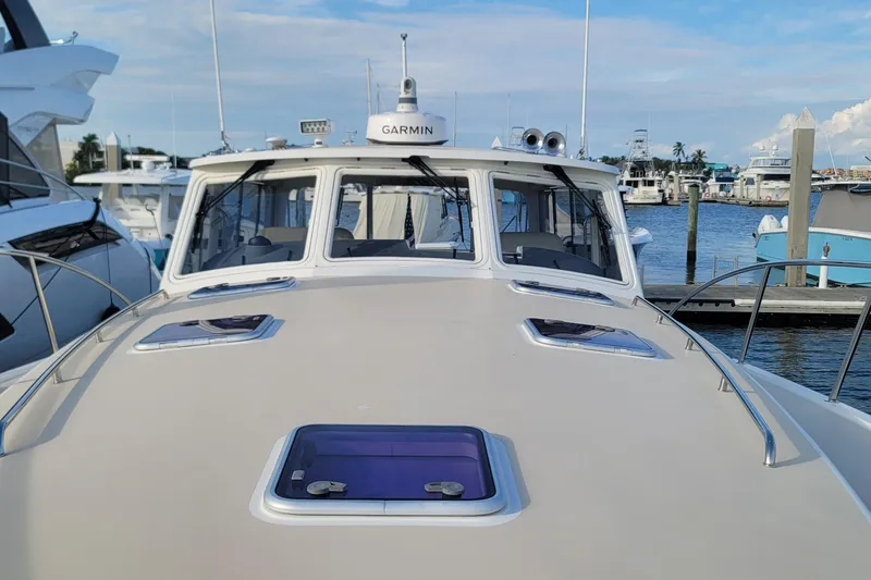 Slide: The Image of 2018 MJM 50z yacht docked at marina, featuring Garmin navigation system. - 48