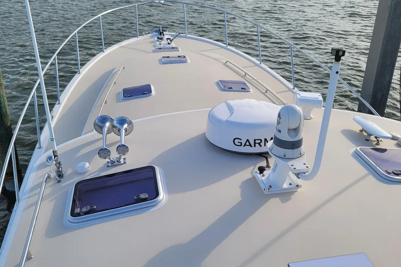 Slide: The Image of 2018 MJM 50z yacht deck with Garmin equipment, docked on calm water. - 49