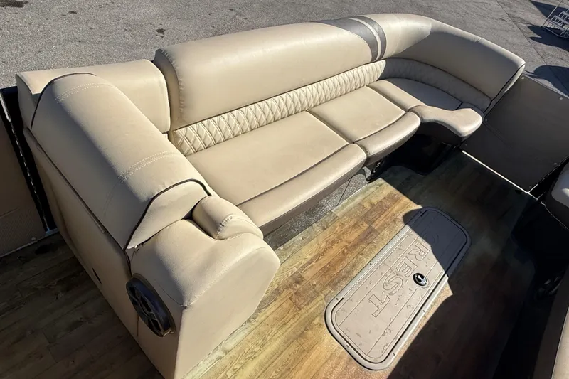 Slide: The Image of 2019 Crest Caribbean 250 SLS boat interior with beige seating and wood flooring. - 13