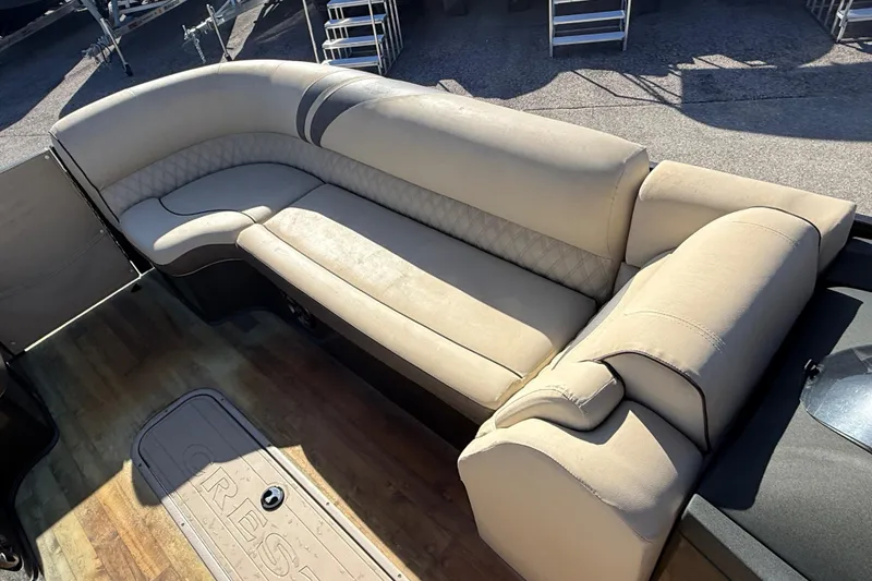 Slide: The Image of Luxurious seating on 2019 Crest Caribbean 250 SLS pontoon boat, featuring beige upholstery. - 15
