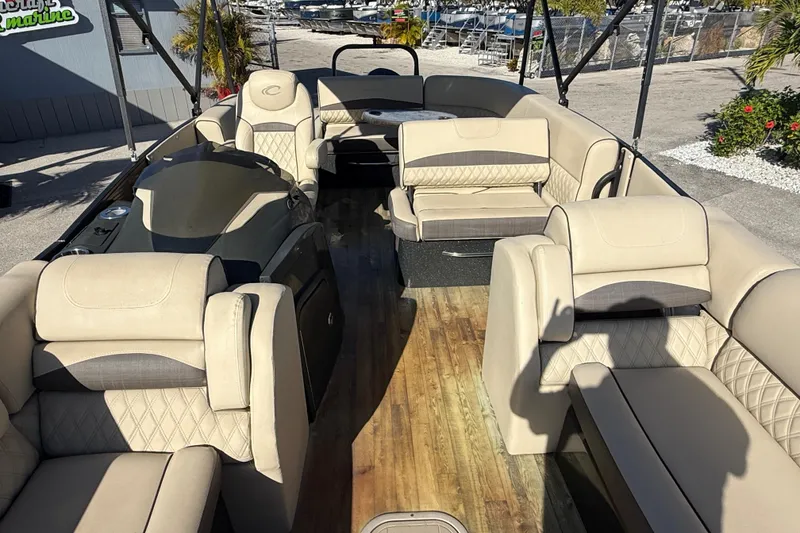 Slide: The Image of 2019 Crest Caribbean 250 SLS pontoon boat with luxurious beige seating and wood-style flooring. - 17