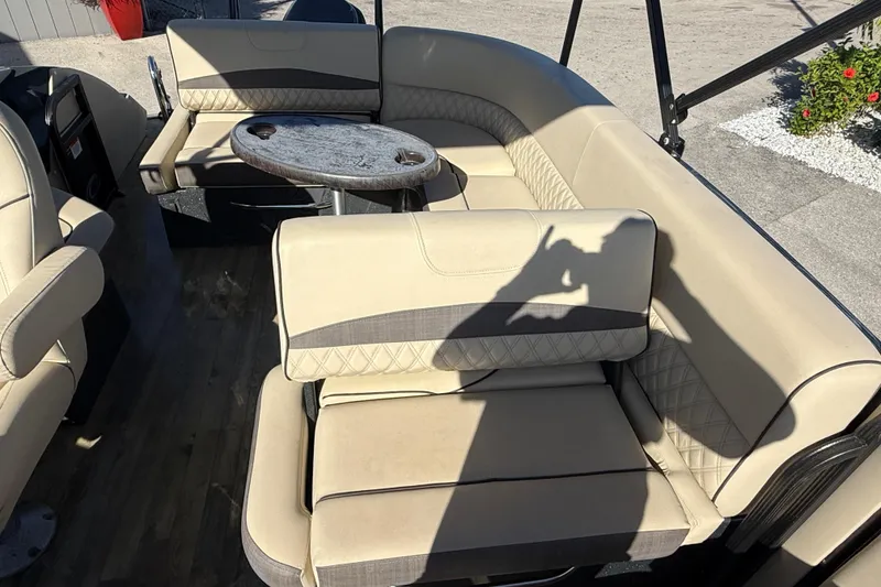 Slide: The Image of 2019 Crest Caribbean 250 SLS boat interior with beige seating and round table. - 19