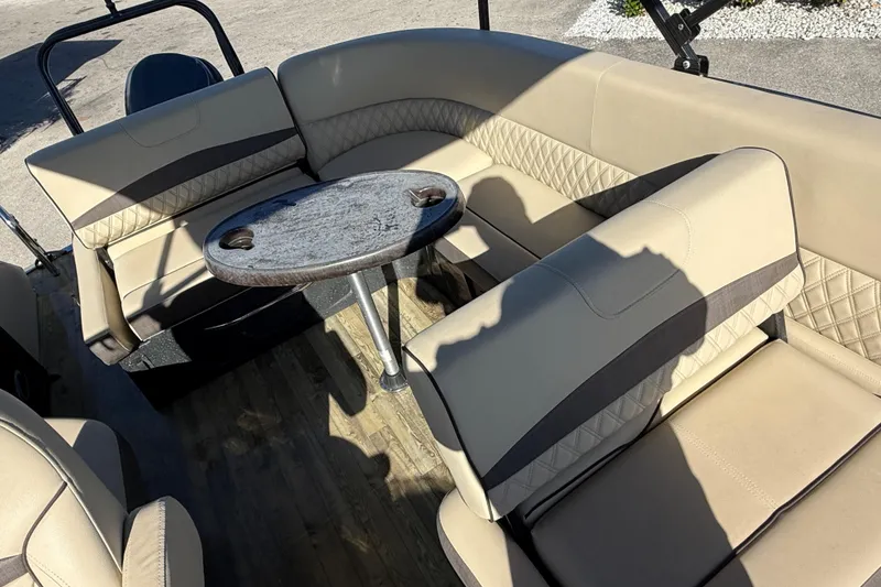 Slide: The Image of 2019 Crest Caribbean 250 SLS boat interior with beige seating and round table. - 20