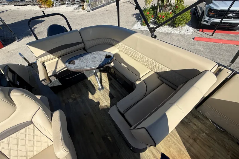 Slide: The Image of 2019 Crest Caribbean 250 SLS boat interior with beige seating and round table. - 21