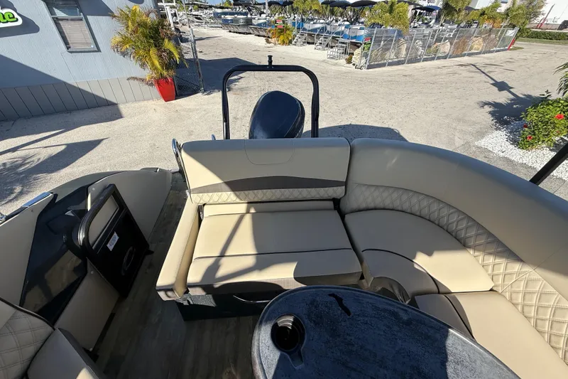 Slide: The Image of Luxurious seating on 2019 Crest Caribbean 250 SLS boat, docked with scenic marina view. - 22