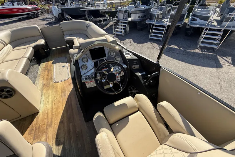 Slide: The Image of 2019 Crest Caribbean 250 SLS boat interior with luxurious seating and modern dashboard. - 24