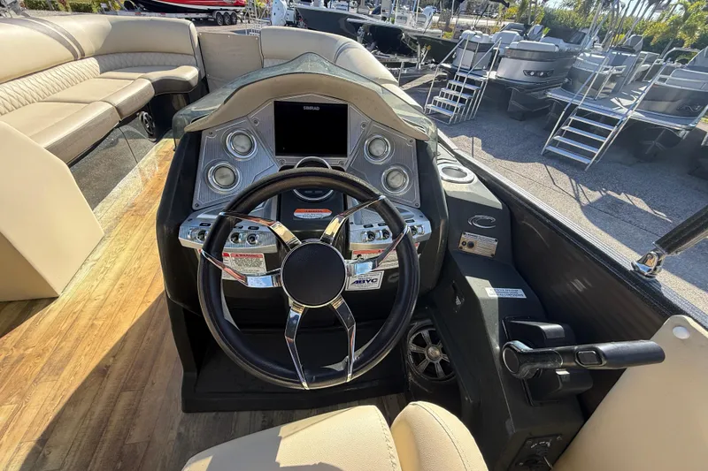 Slide: The Image of 2019 Crest Caribbean 250 SLS boat dashboard with steering wheel and controls. - 25