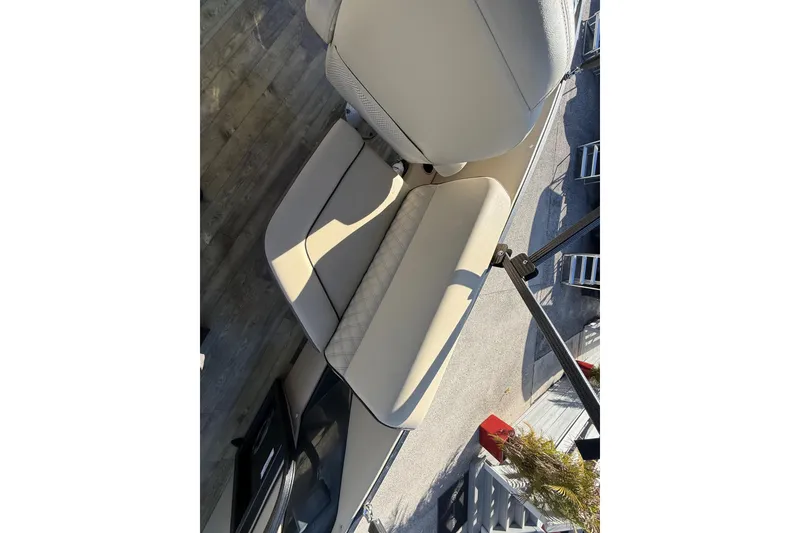 Slide: The Image of 2019 Crest Caribbean 250 SLS boat interior with beige seating and wood flooring. - 26