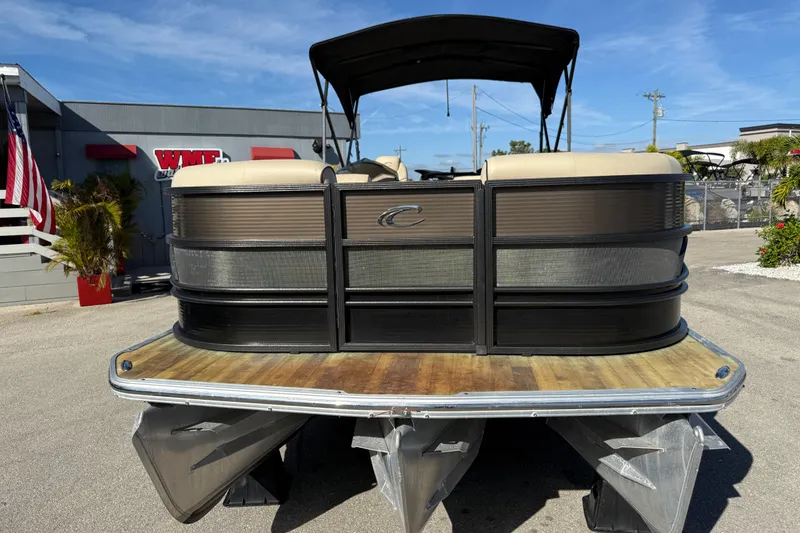 Slide: The Image of 2019 Crest Caribbean 250 SLS pontoon boat with canopy, parked outdoors on a sunny day. - 4