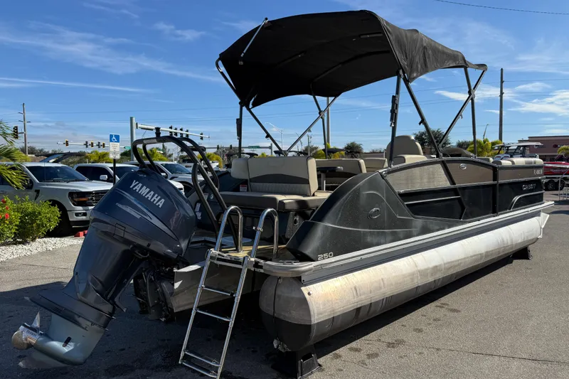 Slide: The Image of 2019 Crest Caribbean 250 SLS pontoon boat with Yamaha outboard motor and canopy. - 6