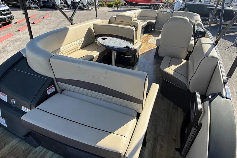 Slide: The Image of 2019 Crest Caribbean 250 SLS pontoon boat interior with luxurious seating and table. - 9