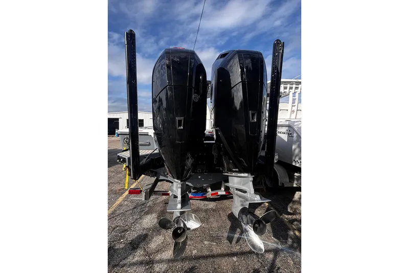 Slide: The Image of 2026 Tidewater 3100 Carolina Bay boat with powerful outboard motor, sleek design, and modern seating. - 10