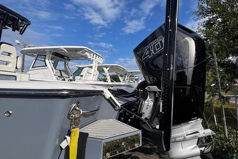 Slide: The Image of 2026 Tidewater 3100 Carolina Bay boat on trailer, featuring powerful outboard engine. - 12