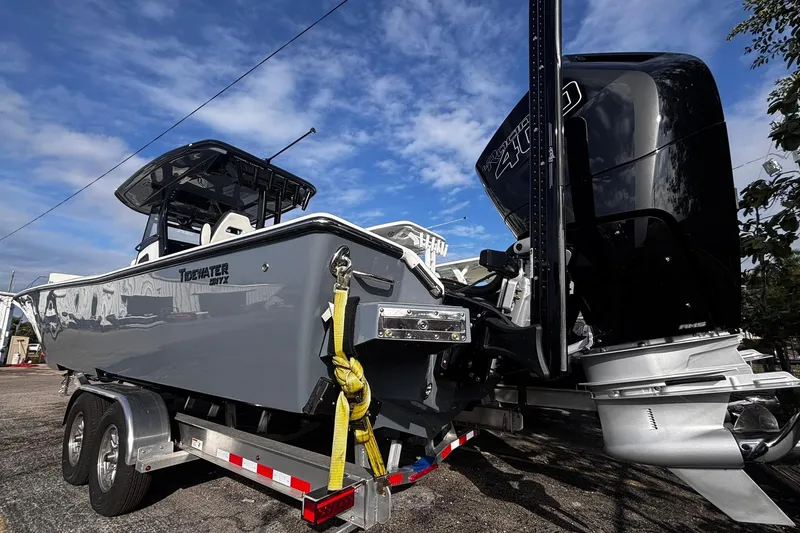 Slide: The Image of 2026 Tidewater 3100 Carolina Bay boat on trailer under blue sky. - 13