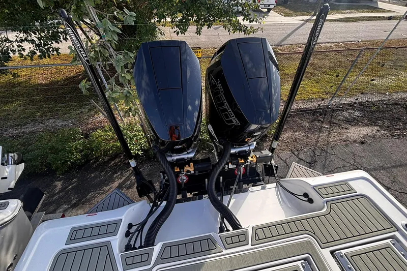 Slide: The Image of 2026 Tidewater 3100 Carolina Bay boat with dual outboard engines, docked outdoors. - 16