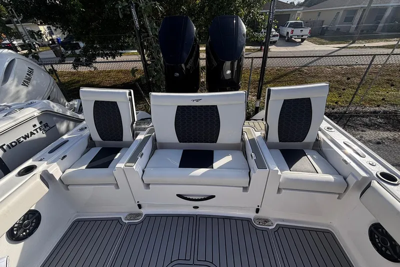 Slide: The Image of 2026 Tidewater 3100 Carolina Bay boat with open storage compartments and dual engines. - 18